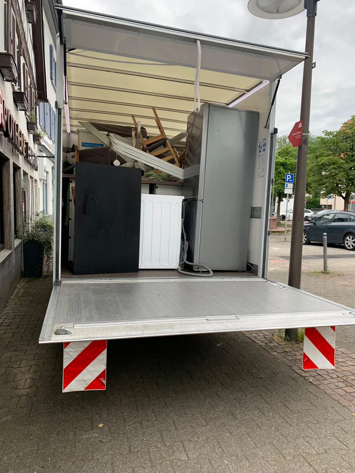 Vehicle loaded with furniture parts and household items