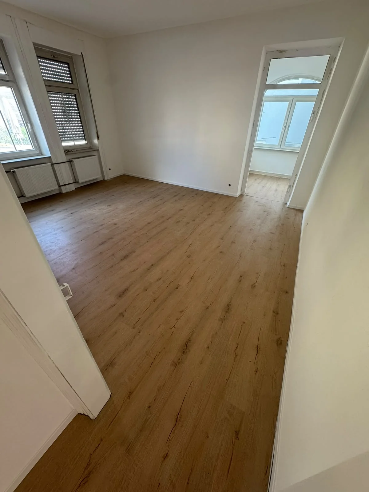 The same room with new flooring and light walls