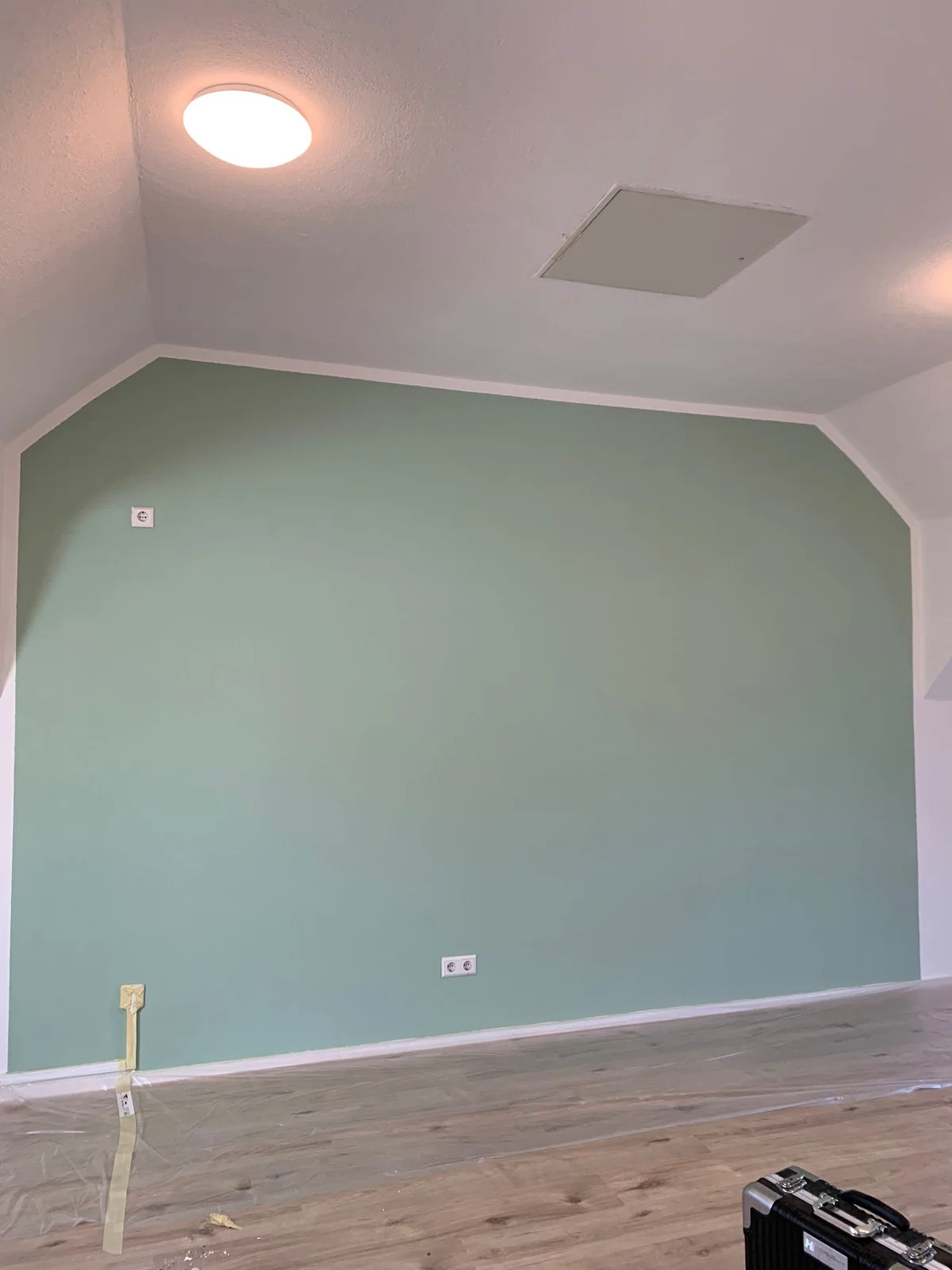The same wall painted green with a light border