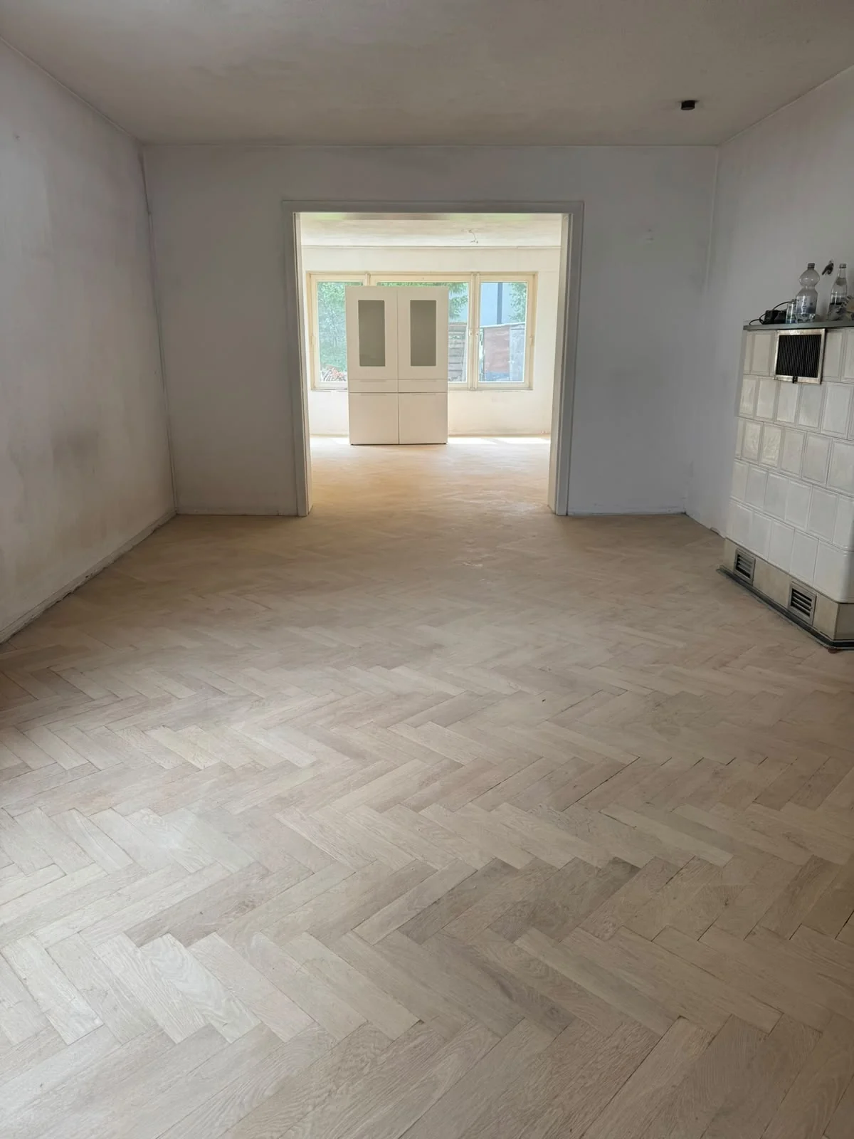 Herringbone-pattern floor in two connected rooms