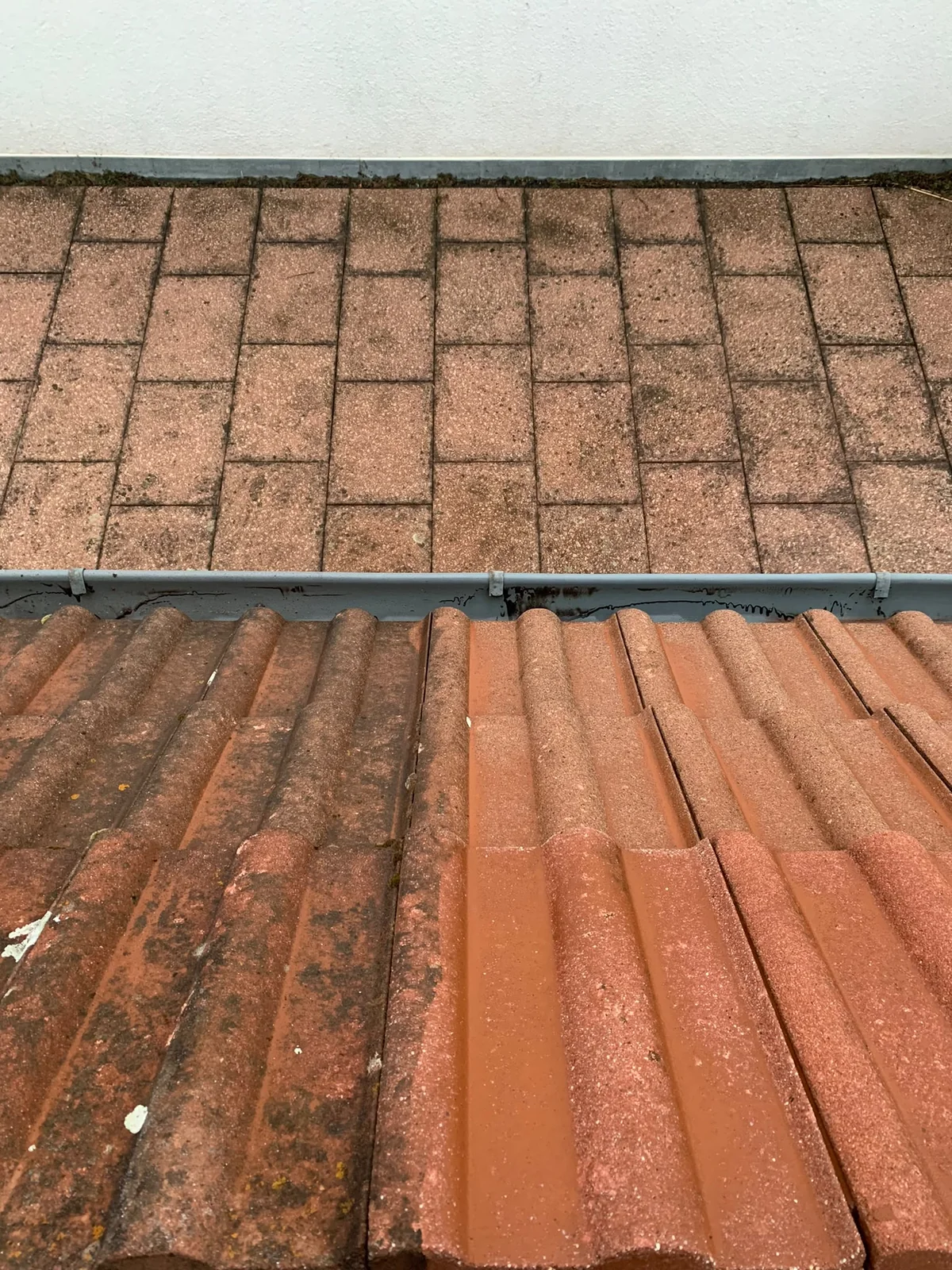 Another roof surface of the same project with areas at different cleaning stages